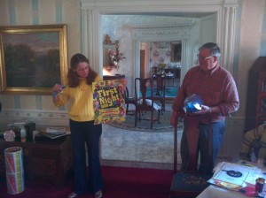 Chapter Chair Polly Keener shows an original poster by Don Peoples about to be given away during the chapter raffle.  That's Polly's husband bib pulling the winning numbers.